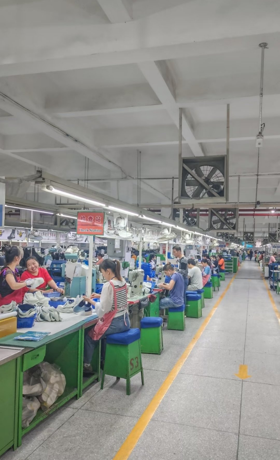 Cozy Foot embroidery station S3 with workers operating multi-head embroidery machines